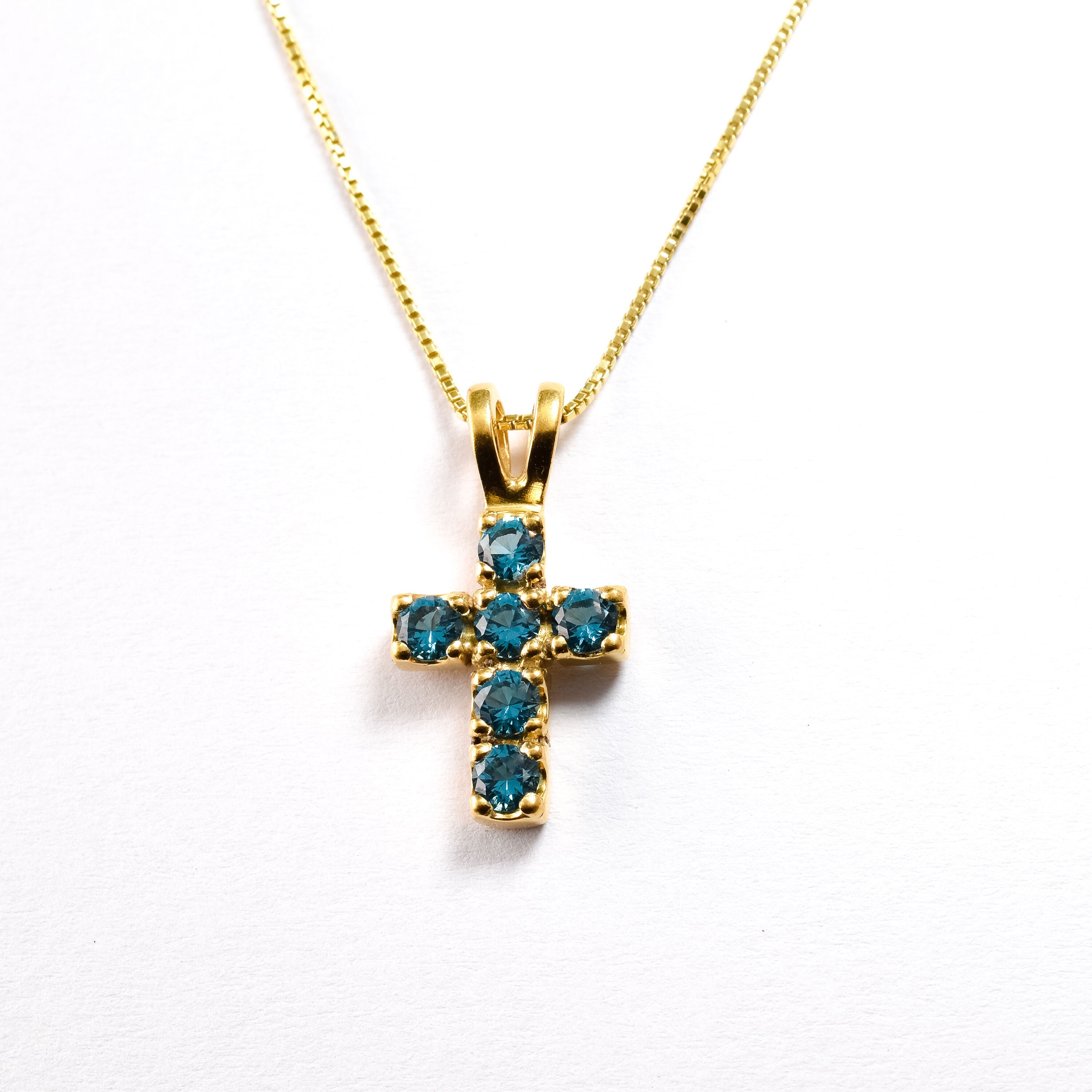 Small Cross Aquamarine March birthstone necklace set in 18k Yellow Gold Vermeil over Solid 925 Sterling Silver,  in stunning blue color and clarity, and in prong setting. Blue cross pendant perfect for religious activities, ang thoughtful personalized gift idea. Blue Aquamarine gemstone brings tranquility, aids in self-expression, and protects travelers. For courage, communication, and soothing.