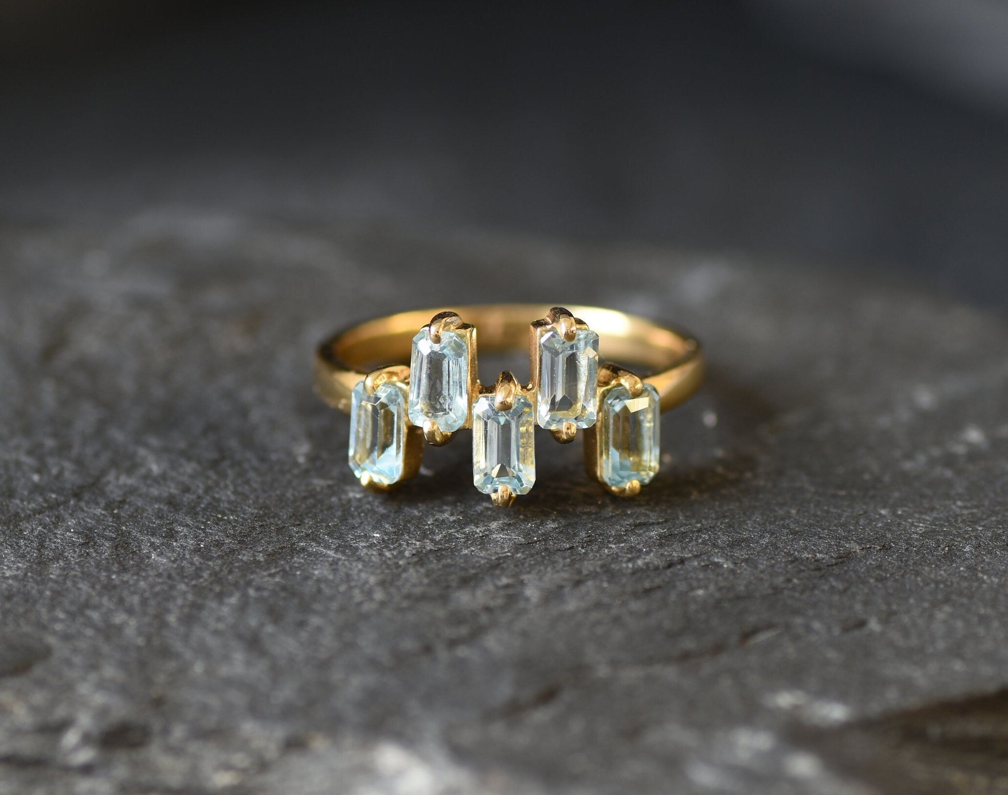 Blue gemstone ring in gold ideal for elegant fashion or birthday gift.