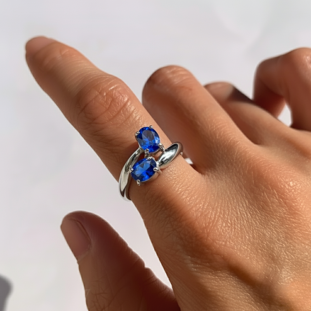 Elegant two-stone sapphire ring in sterling silver, perfect for September birthdays and symbolizes truth and faithfulness.