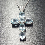 Blue Topaz pendant styled as a delicate religious symbol