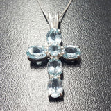 Blue Topaz pendant styled as a delicate religious symbol