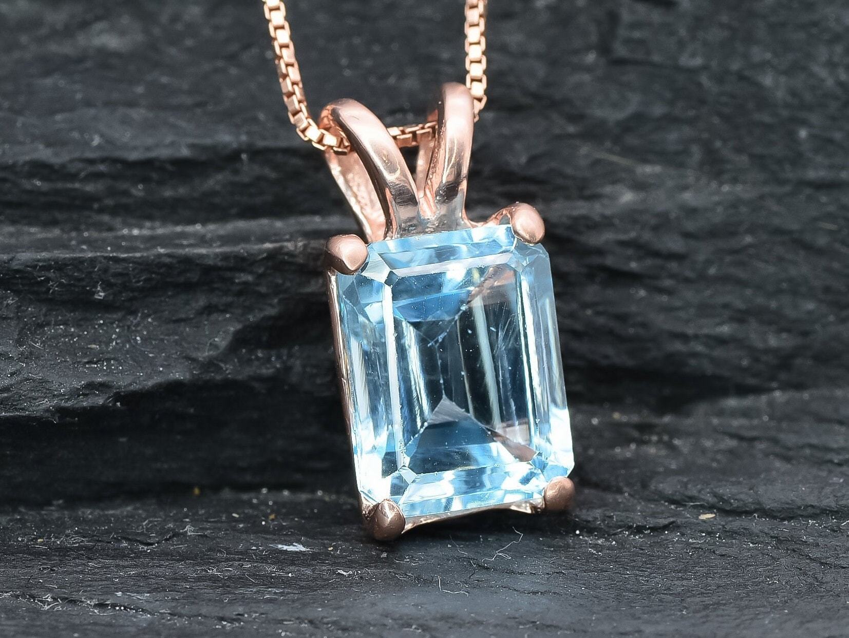 Rose gold vermeil version of blue topaz pendant with emerald cut gemstone and soft blush-toned setting