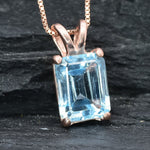 Rose gold vermeil version of blue topaz pendant with emerald cut gemstone and soft blush-toned setting