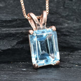Rose gold vermeil version of blue topaz pendant with emerald cut gemstone and soft blush-toned setting
