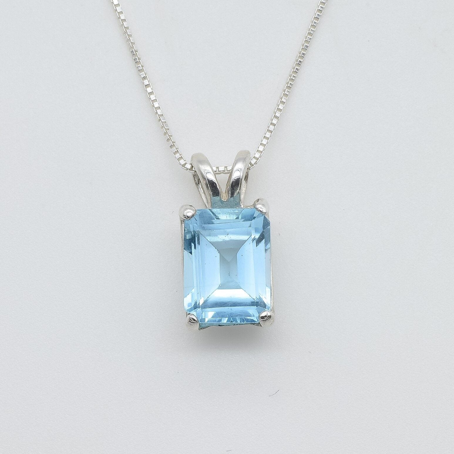 Blue topaz pendant set in 925 sterling silver with emerald cut gemstone and classic prong setting