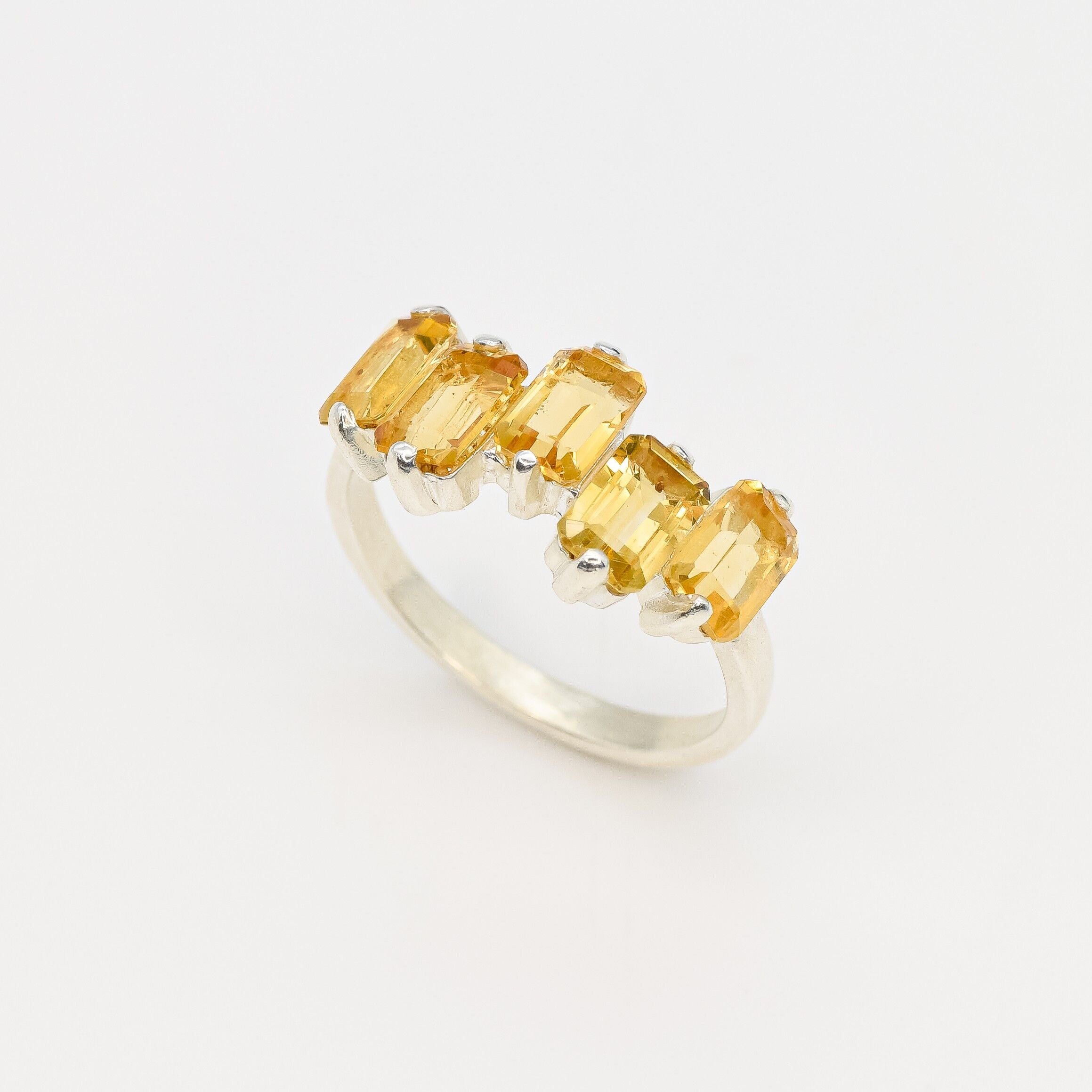 Citrine ring with baguette-cut stones in a sleek sterling silver setting