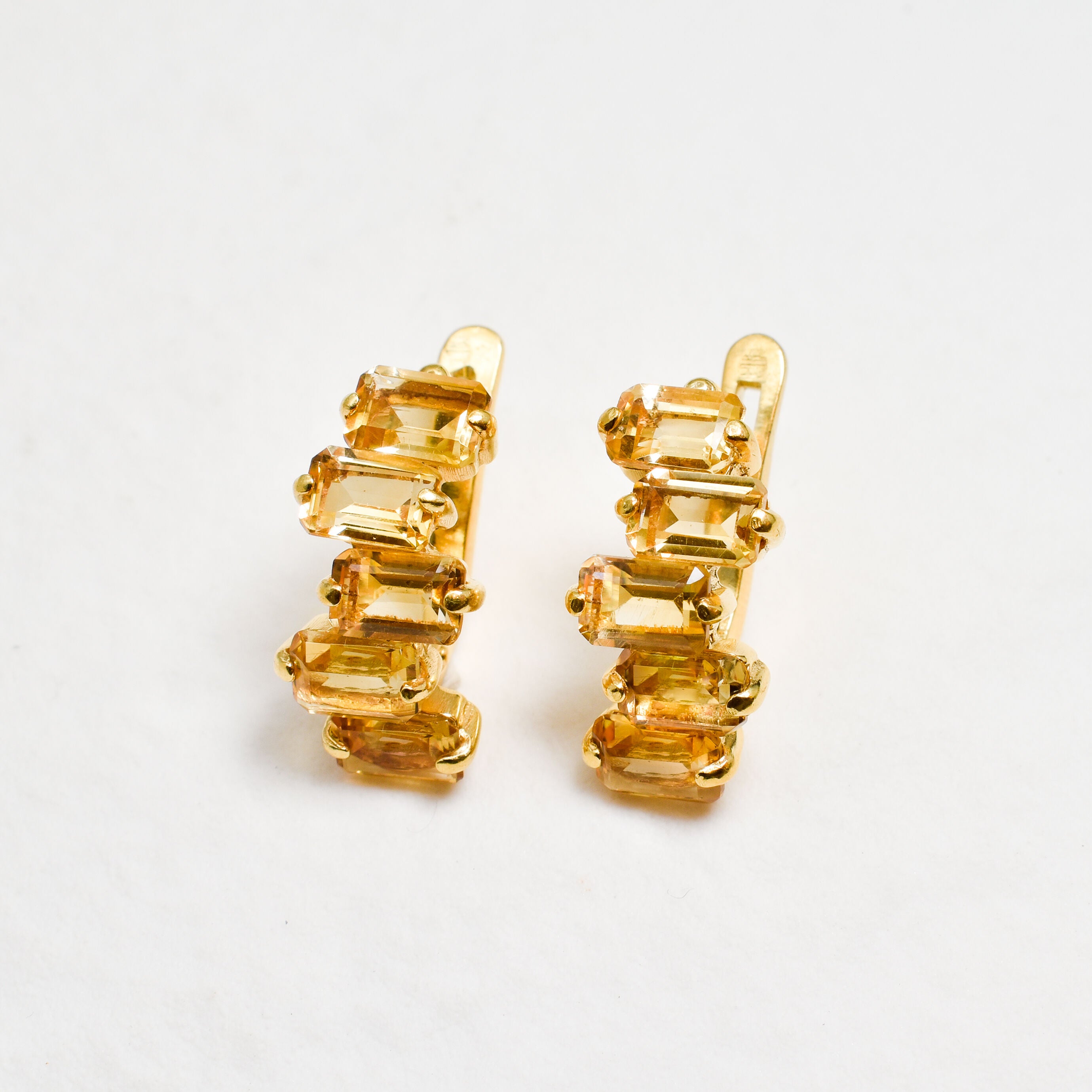 Cluster drop earrings in gold featuring multiple diamond-cut citrine stones with secure English lock closure