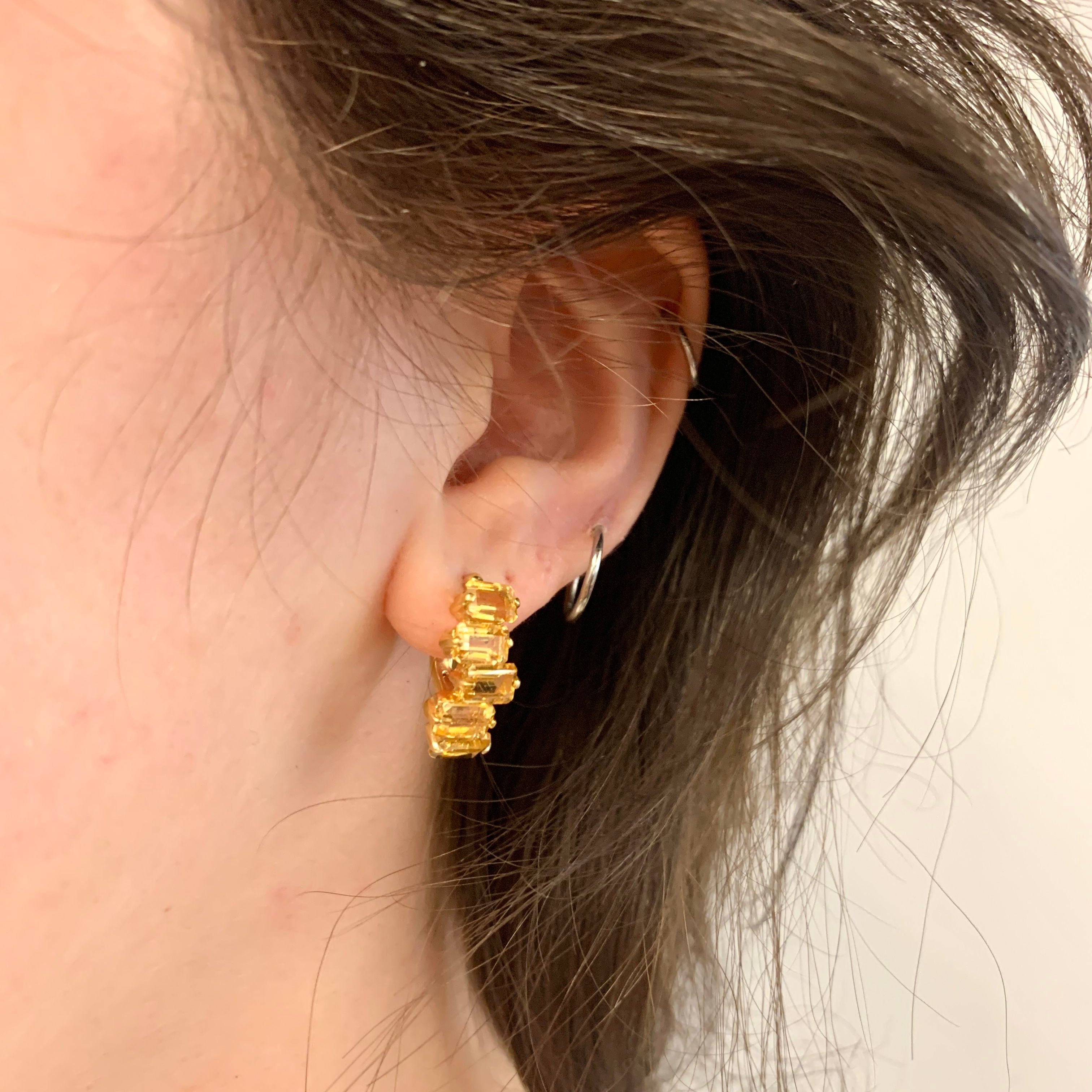 Gold citrine earrings worn on ear showcasing secure lever back closure and gemstone brilliance