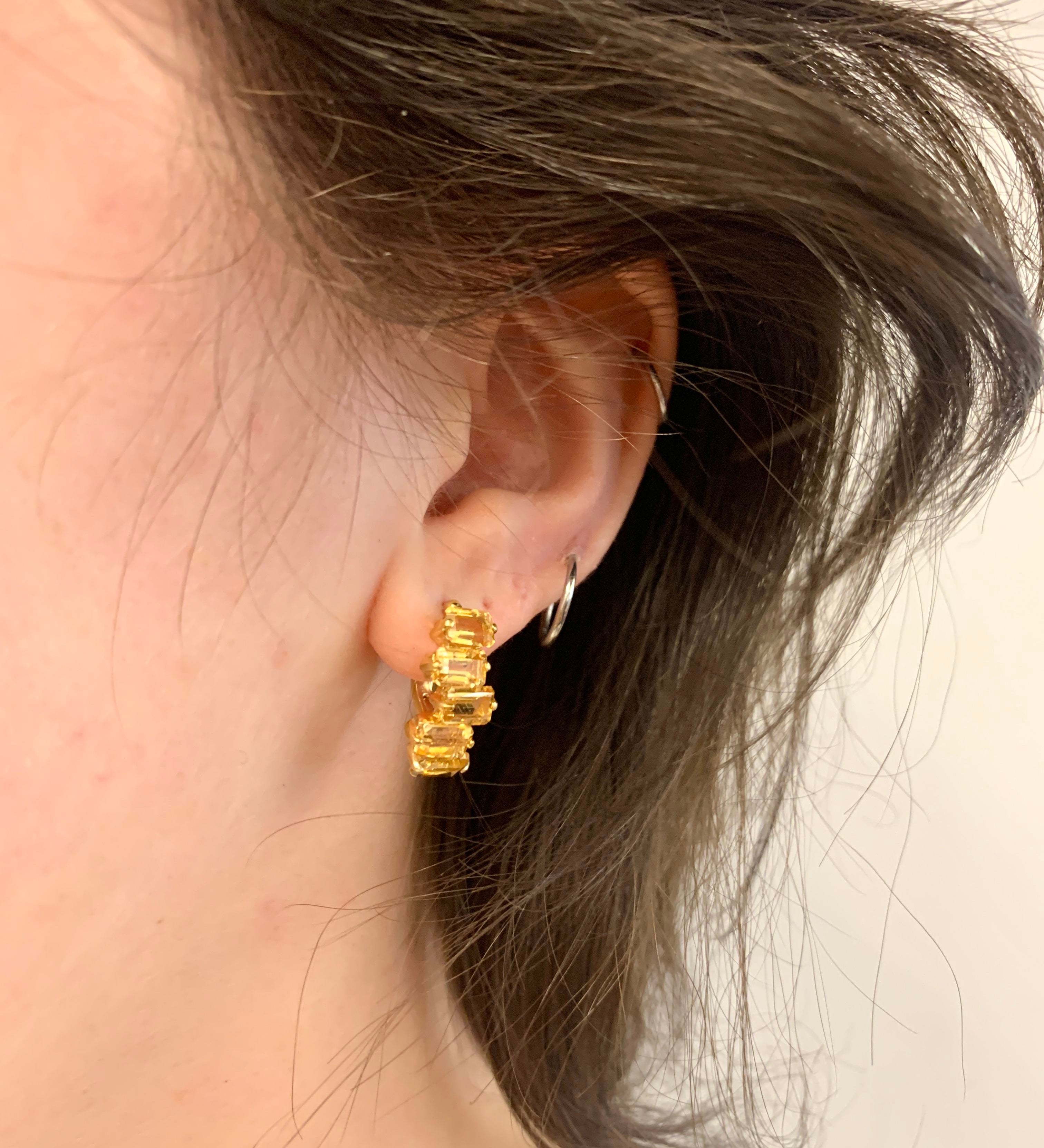 Gold citrine earrings worn on ear showcasing secure lever back closure and gemstone brilliance
