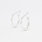 Close-up image of solid 925 sterling silver hoop earrings with polished finish