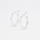 Close-up image of solid 925 sterling silver hoop earrings with polished finish