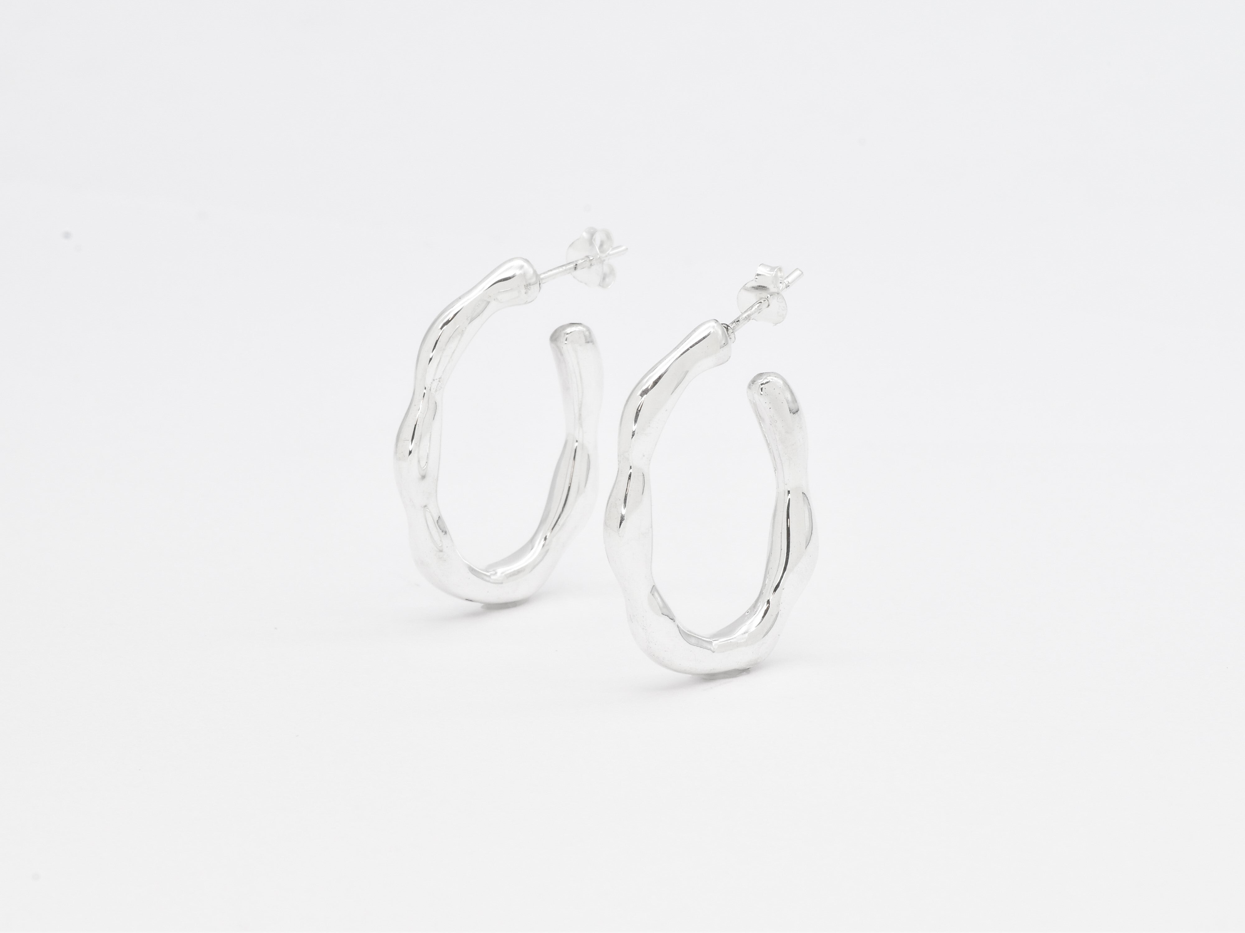 Close-up image of solid 925 sterling silver hoop earrings with polished finish