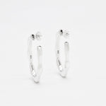 Close-up image of solid 925 sterling silver hoop earrings with polished finish