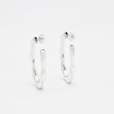 Close-up image of solid 925 sterling silver hoop earrings with polished finish