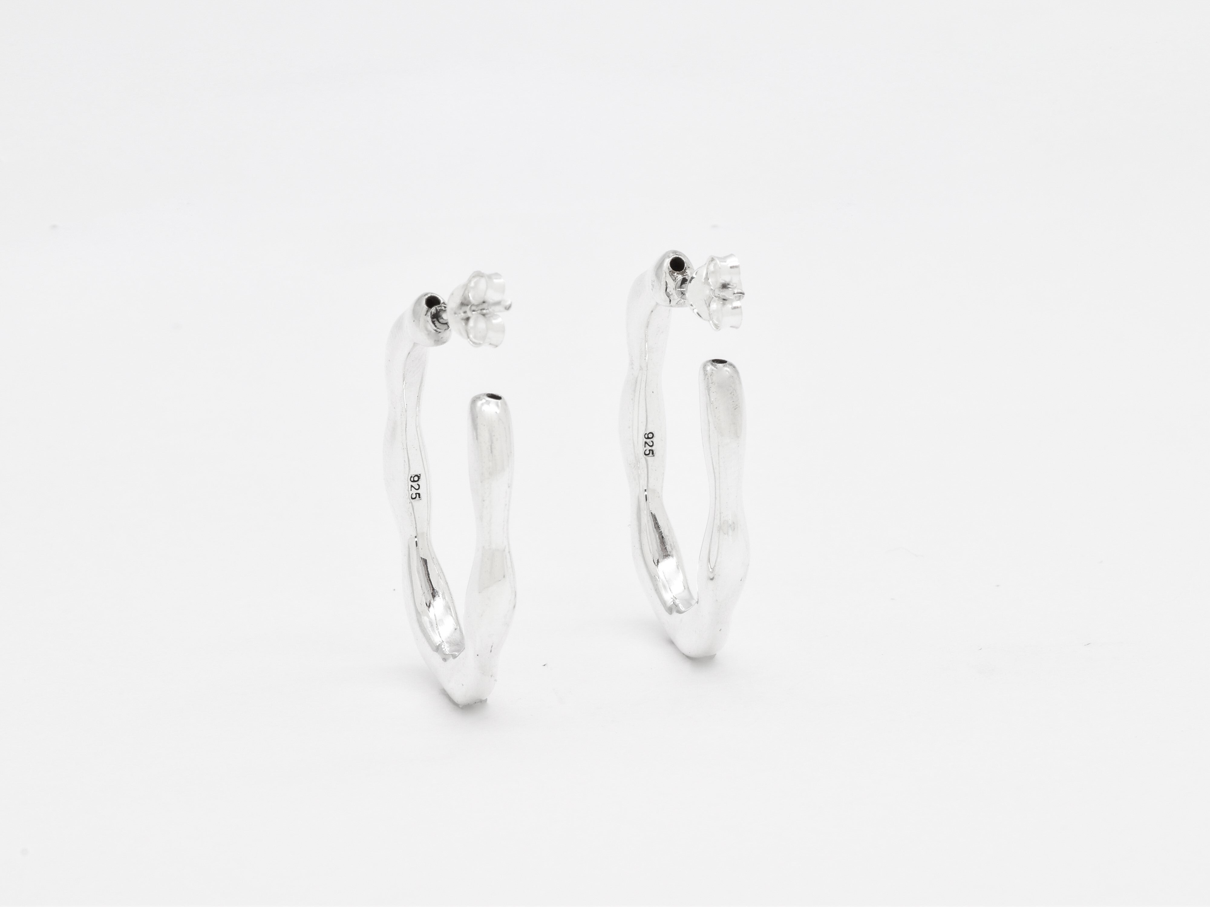 Close-up image of solid 925 sterling silver hoop earrings with polished finish