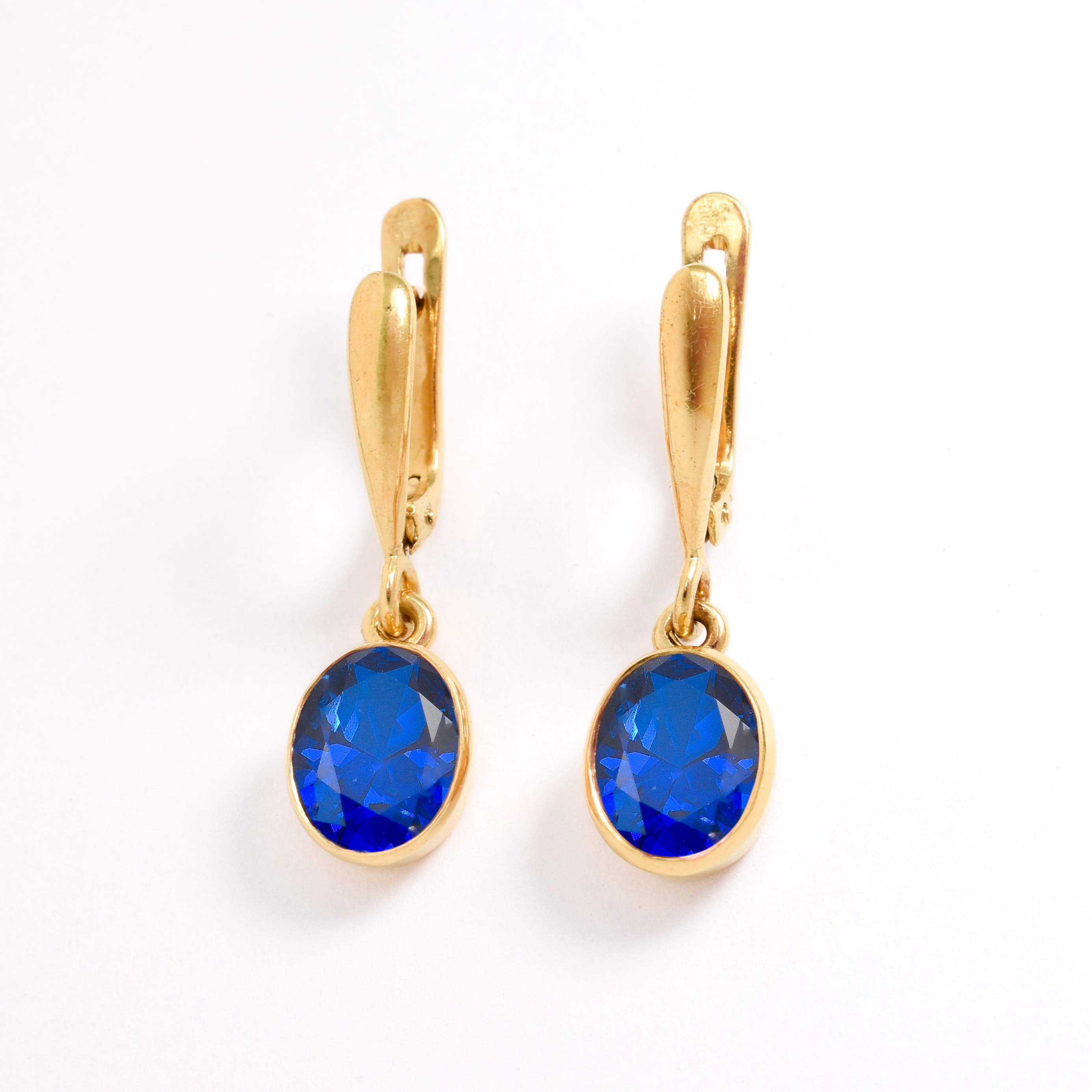 Created Sapphire Earrings made in 18k Gold Vermeil with Oval Created Blue Sapphire in Bezel setting, September Birthstone gift idea, symbolizes sincerity, truth, and faithfulness, ideal for everyday wear and perfect for birthday gifting and special occasions.