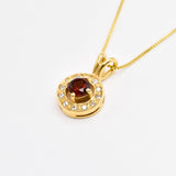 Red Garnet January birthstone necklace crafted in 18k yellow gold over sterling silver, in round cut and prong setting, surrounded with small CZ diamonds. Dainty natural garnet pendant that boosts confidence, enhances courage, and inspires love and success. For passion, protection, & vitality.