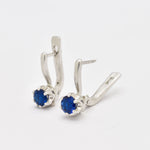 Elegant 925 Sterling Silver Earrings with a radiant Round Created Blue Sapphire, ideal for daily wear and September birthdays.