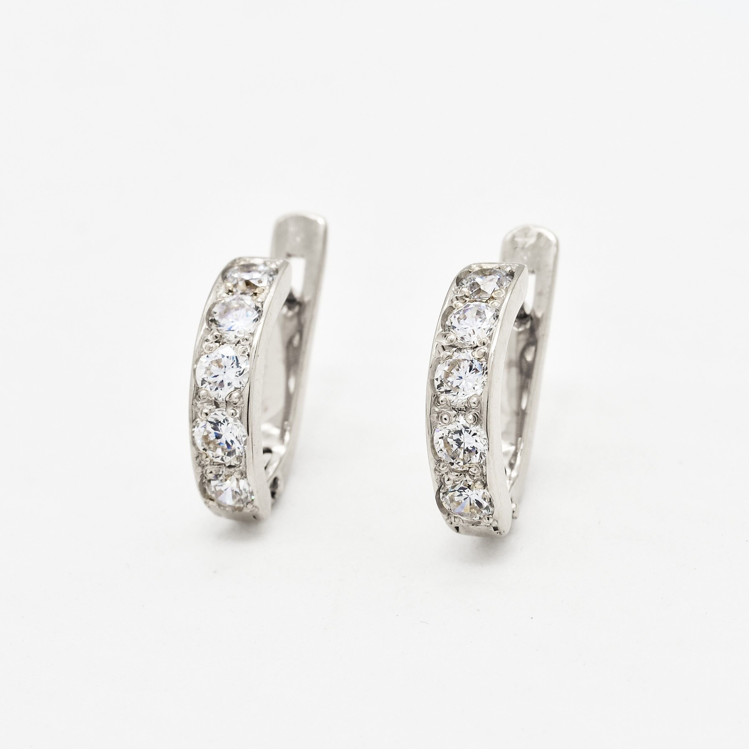 Diamond April birthstone earrings in round cut and prong setting. Half hoop earrings ideal gift for her or anniversary present. Diamond - Symbol of eternal love, purity, and inner strength. For clarity, and abundance