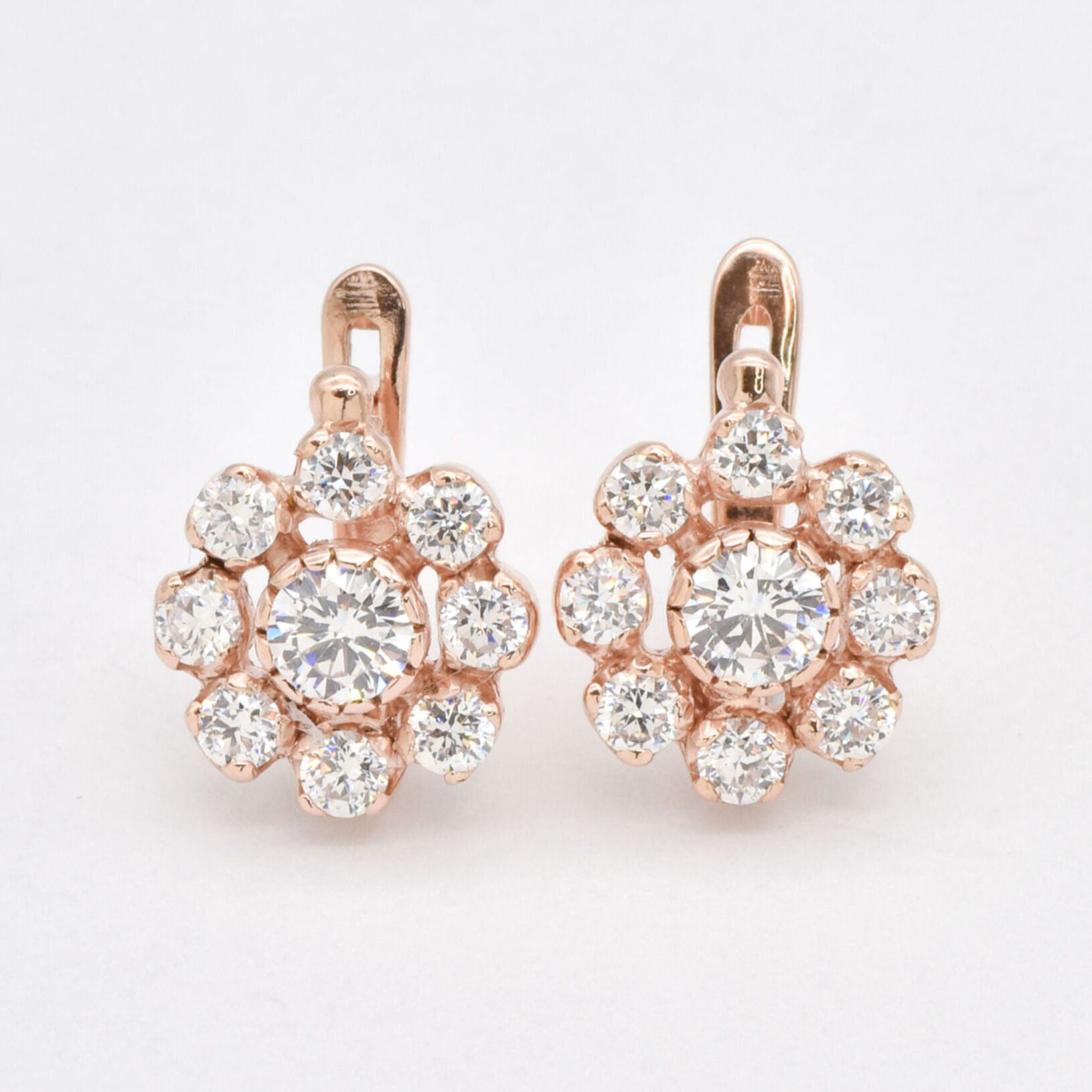 18k Rose gold plated earrings with Diamond April birthstone in round cut and prong setting. Flower studs ideal for special occasions and personalized gift. Symbol of eternal love, purity, and inner strength. For clarity, abundance