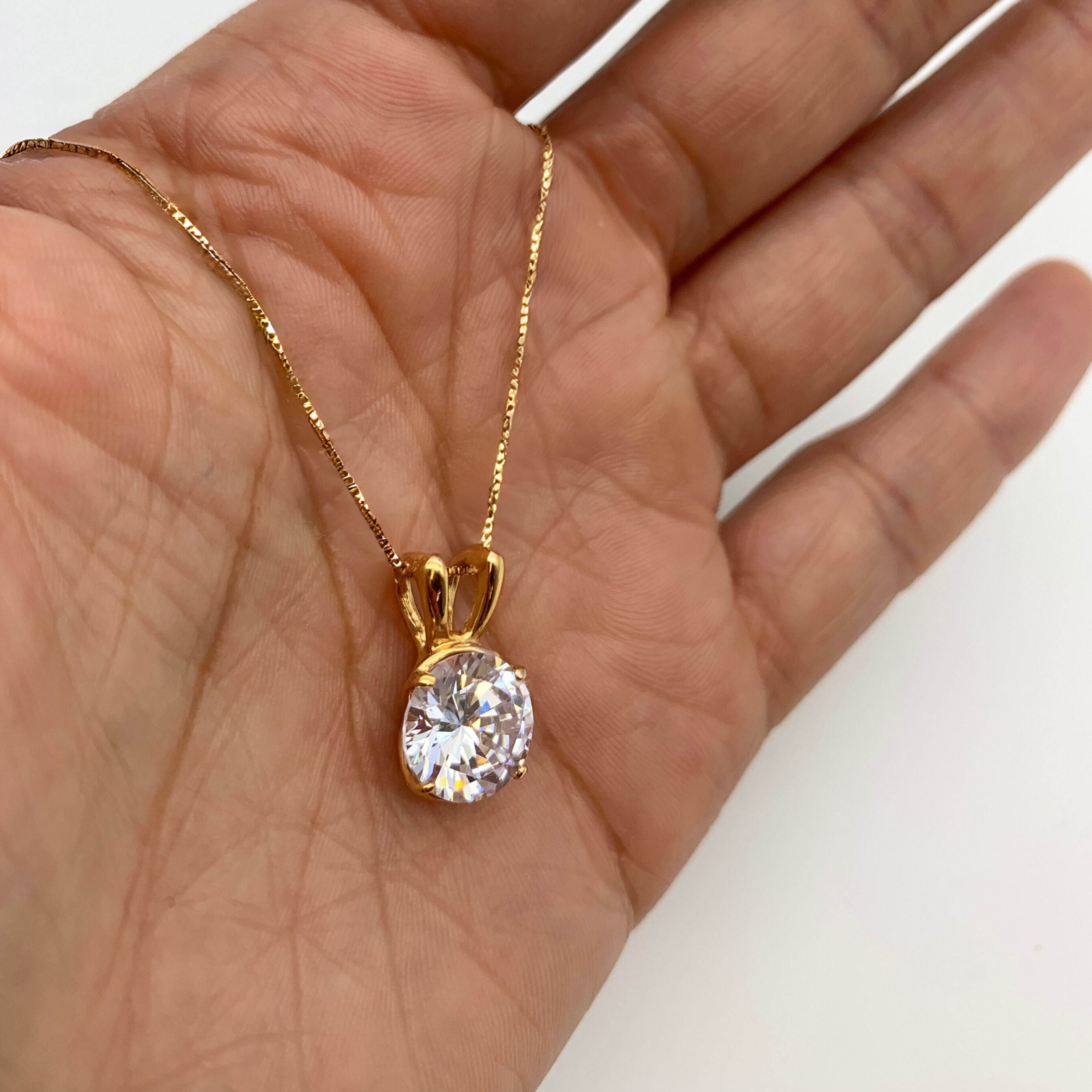 18k Yellow gold plated pendant with Diamond April birthstone in diamond and prong setting. Round solitaire necklace ideal for special occasions and everyday wear. Round diamond necklace symbolizing eternal love, purity, and inner strength. Ideal gift for her, and as personalized gift.