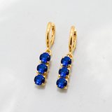 Created Sapphire Earrings made in 18k Gold Vermeil with Round Created Blue Sapphire in Three-Stone setting, September Birthstone gift idea, symbolizes sincerity, truth, and faithfulness, ideal for everyday wear and perfect for birthday gifting and special occasions.