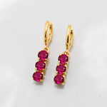 Created Ruby Earrings made in 18k Gold Vermeil with Round Created Red Ruby in Three-Stone setting, July Birthstone gift idea, symbolizes nobility, purity, and passion, ideal for everyday wear and perfect for birthday gifting and special occasions.