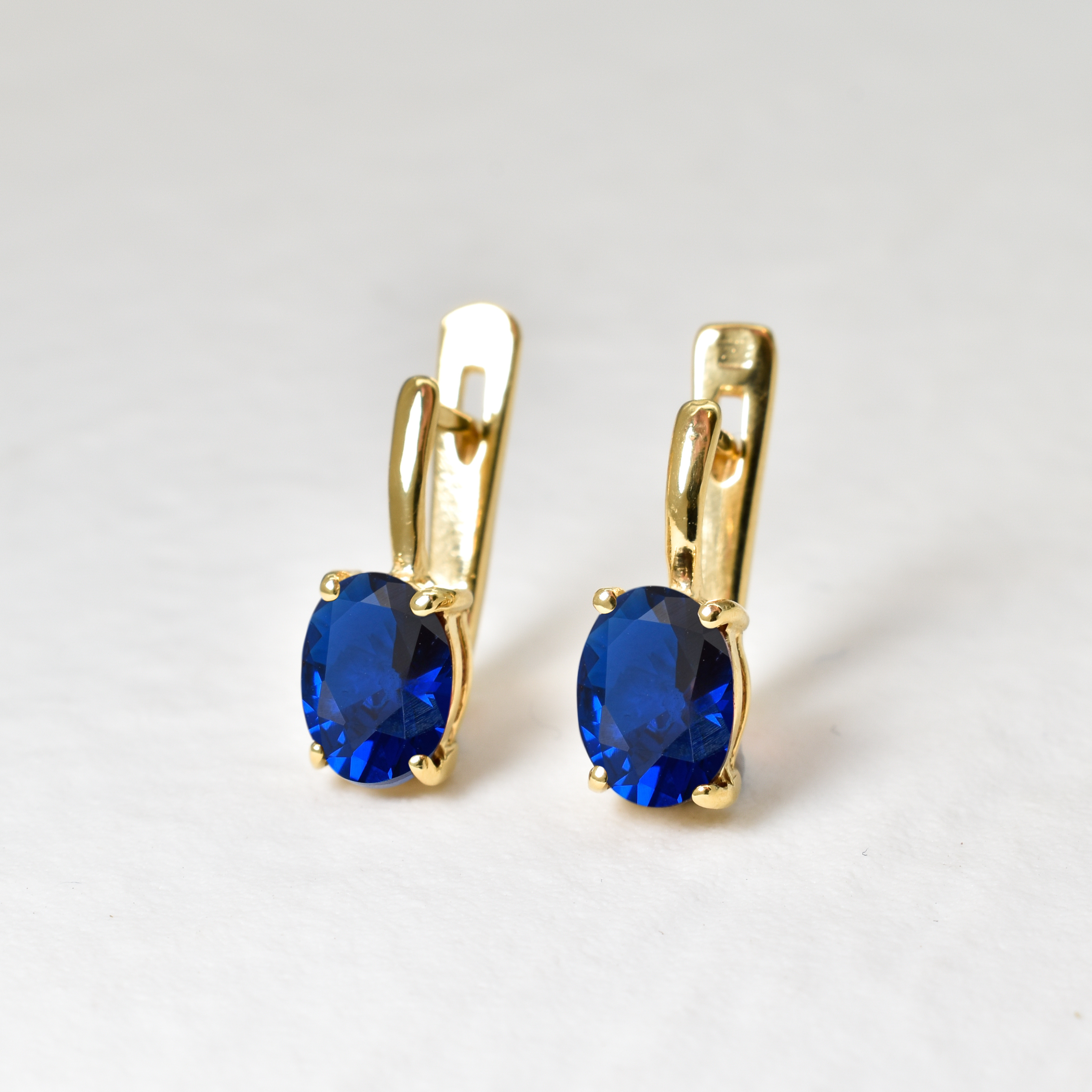 Created Sapphire Earrings made in 18k Gold Vermeil with Oval Created Blue Sapphire in Prong setting, September Birthstone gift idea, symbolizes sincerity, truth, and faithfulness, ideal for everyday wear and perfect for birthday gifting and special occasions.