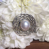 Natural Pearl sourced from Japan in a circular drop design, promotes emotional balance and grace, suitable for elegant evening looks and birthday surprises.