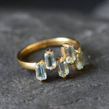 Five-stone blue topaz ring perfect for modern outfits or special occasions.