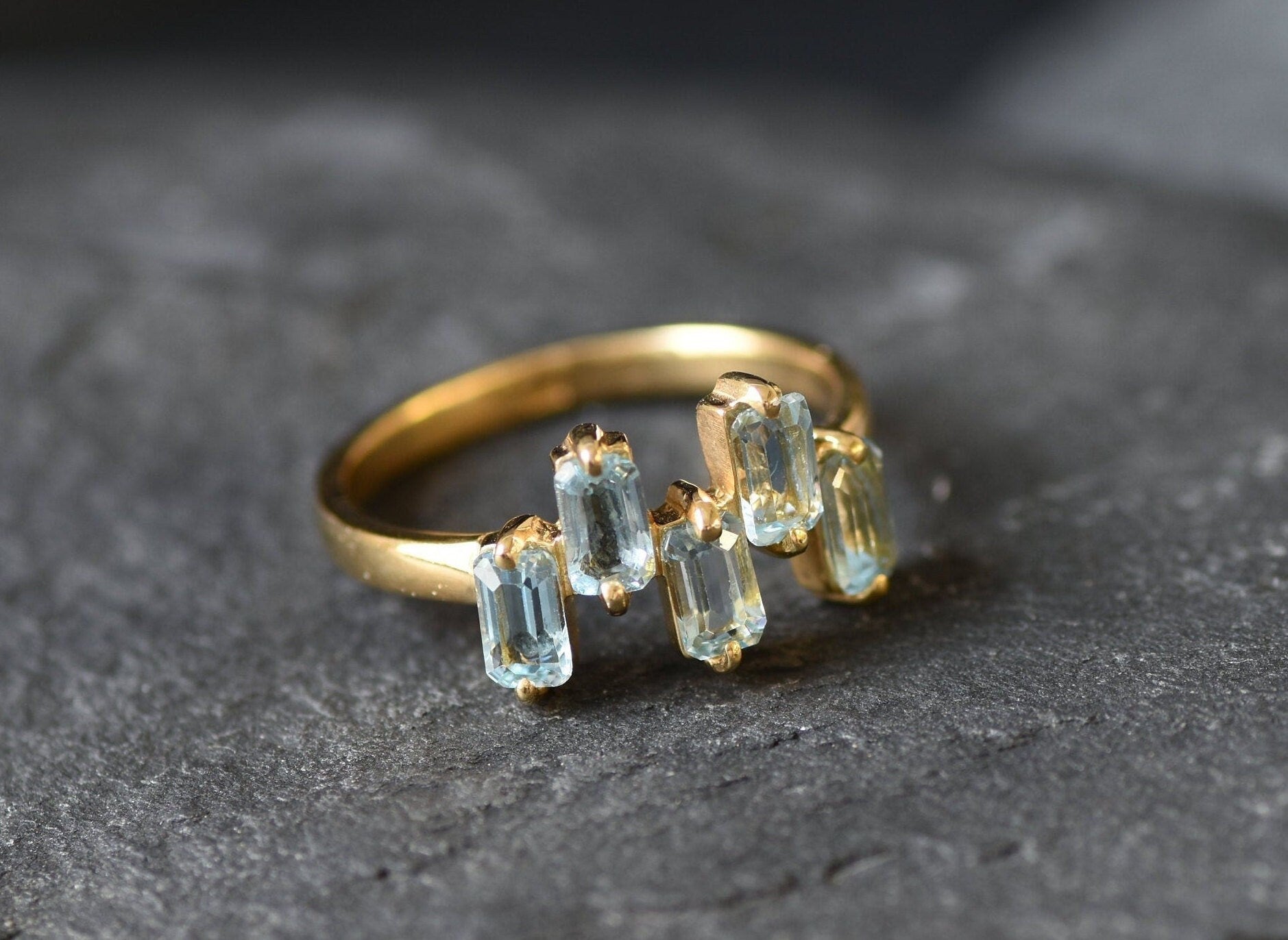 Five-stone blue topaz ring perfect for modern outfits or special occasions.