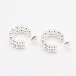 Flat lay of solid 925 sterling silver beaded hoop earrings on white surface