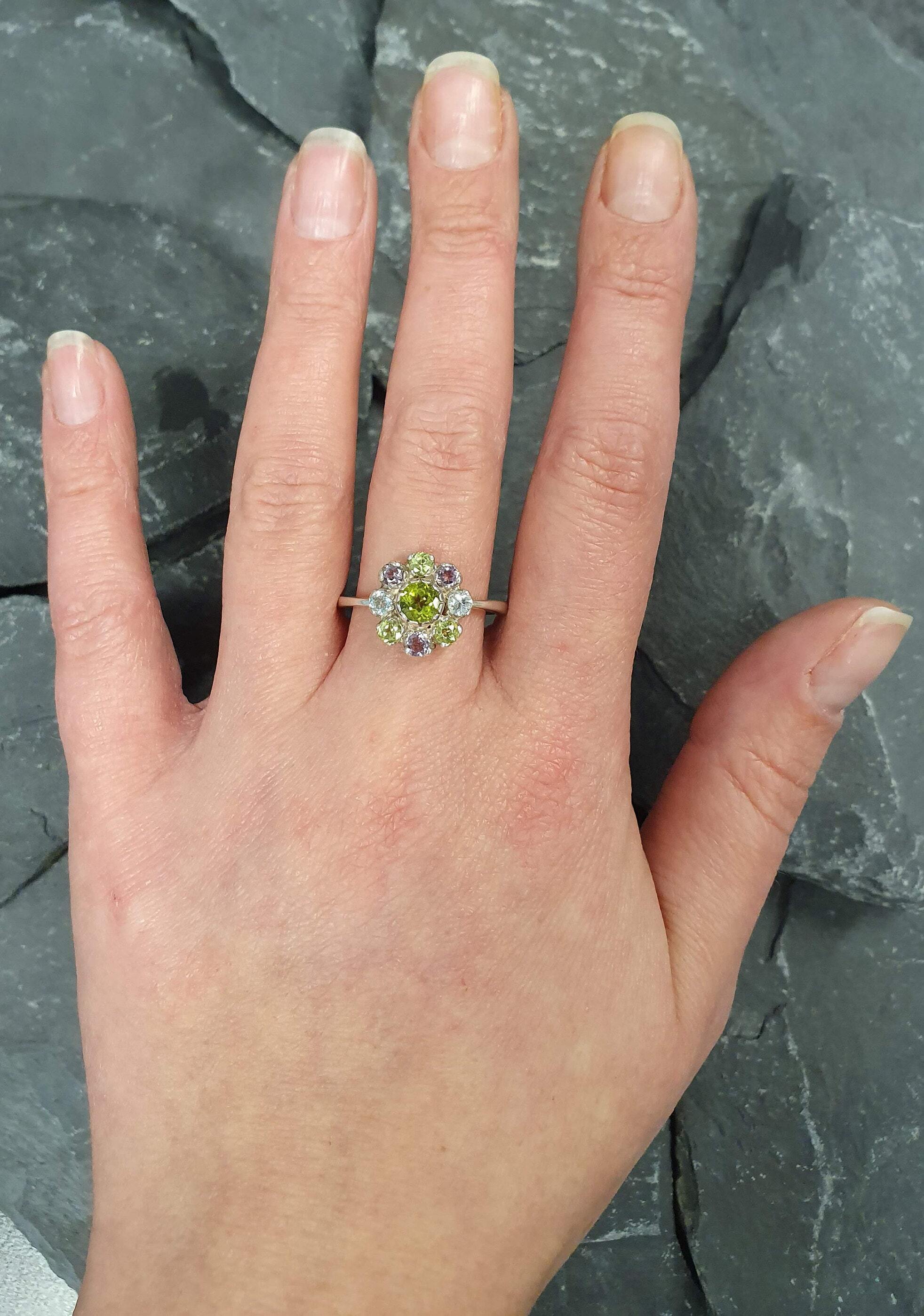 Floral Peridot ring styled on middle finger with Amethyst and Blue Topaz accents, perfect for everyday wear.