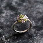 Flower-inspired Peridot ring with Amethyst and Blue Topaz gemstones in sterling silver, timeless jewelry design.