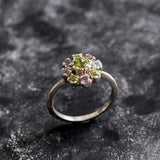 Flower-inspired Peridot ring with Amethyst and Blue Topaz gemstones in sterling silver, timeless jewelry design.