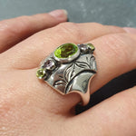 Natural Peridot & Amethyst ring styled on index finger with elegant outfit, enhancing a sophisticated appearance.