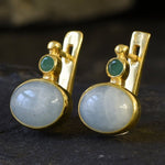 A scenic sunset over a calm lake, with vibrant orange and purple hues reflecting on the water's surface.