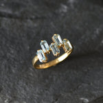 Gold band ring with topaz gems ideal for fashionable gifting or birthstone charm.