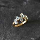 Gold band ring with topaz gems ideal for fashionable gifting or birthstone charm.