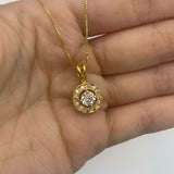 18k Yellow gold plated necklace with Diamond April birthstone in diamond cut and prong setting, dainty round diamond pendant resting in an open palm.
