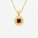 Natural Garnet January birthstone necklace crafted in 18k yellow gold over sterling silver, in round cut and prong setting, surrounded with small CZ diamonds. Dainty red garnet pendant that boosts confidence, enhances courage, and inspires love and success. For passion, protection, & vitality.