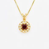 Natural Garnet January birthstone necklace crafted in 18k yellow gold over sterling silver, in round cut and prong setting, surrounded with small CZ diamonds. Dainty red garnet pendant that boosts confidence, enhances courage, and inspires love and success. For passion, protection, & vitality.