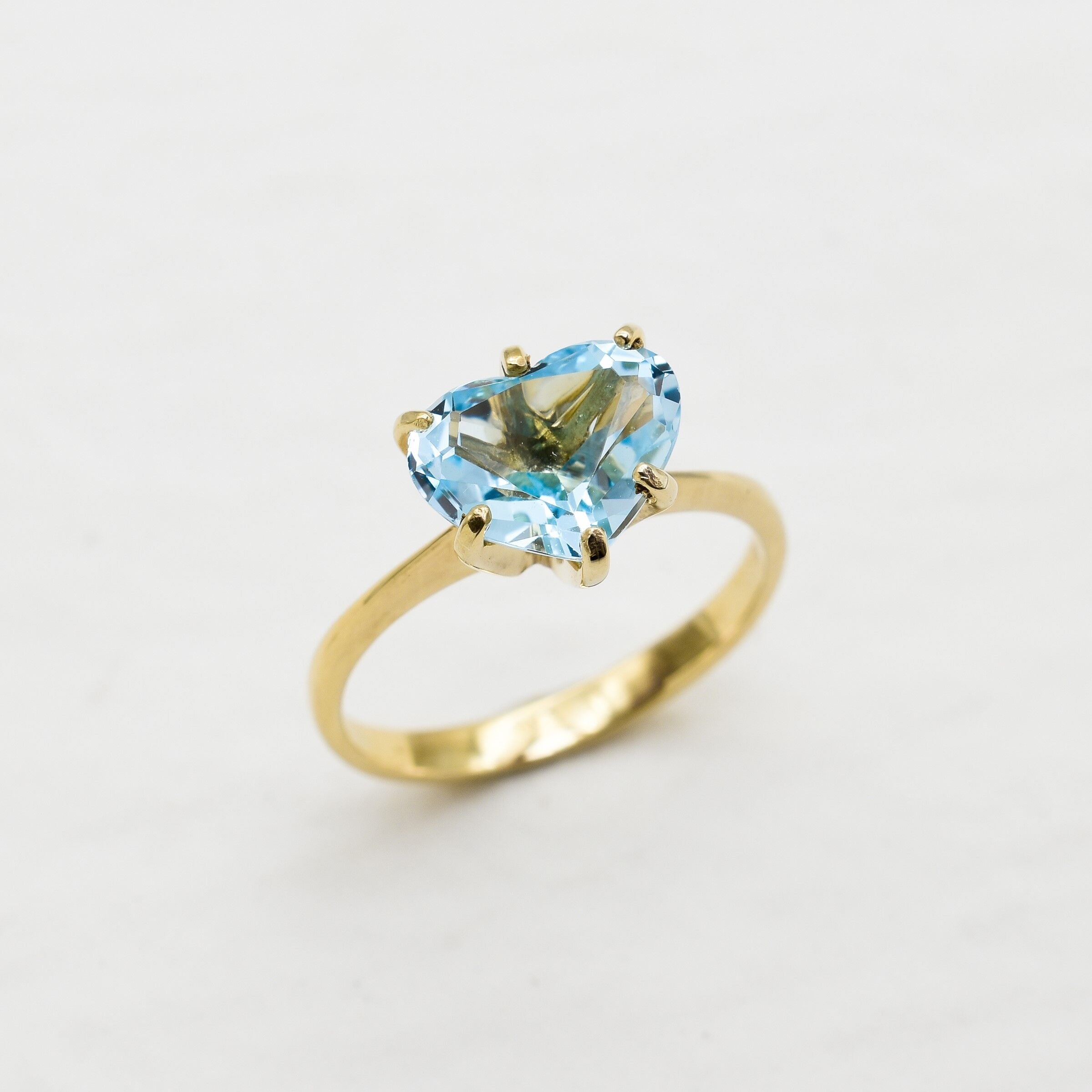 Heart Aquamarine March birthstone ring crafted in 18k Yellow Gold over Solid 925 Sterling Silver. Blue gemstone ring perfect as a valentine's gift idea, can be worn as an everyday ring that brings tranquility, aids in self-expression, and protects travelers. For courage, communication, soothing