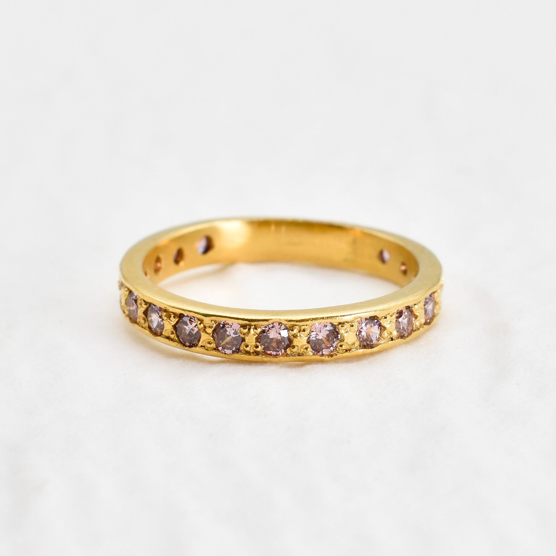 Yellow gold plated ring with morganite gemstones in small round cut. Dainty eternity ring ideal for everyday wear and stacking rings. 
