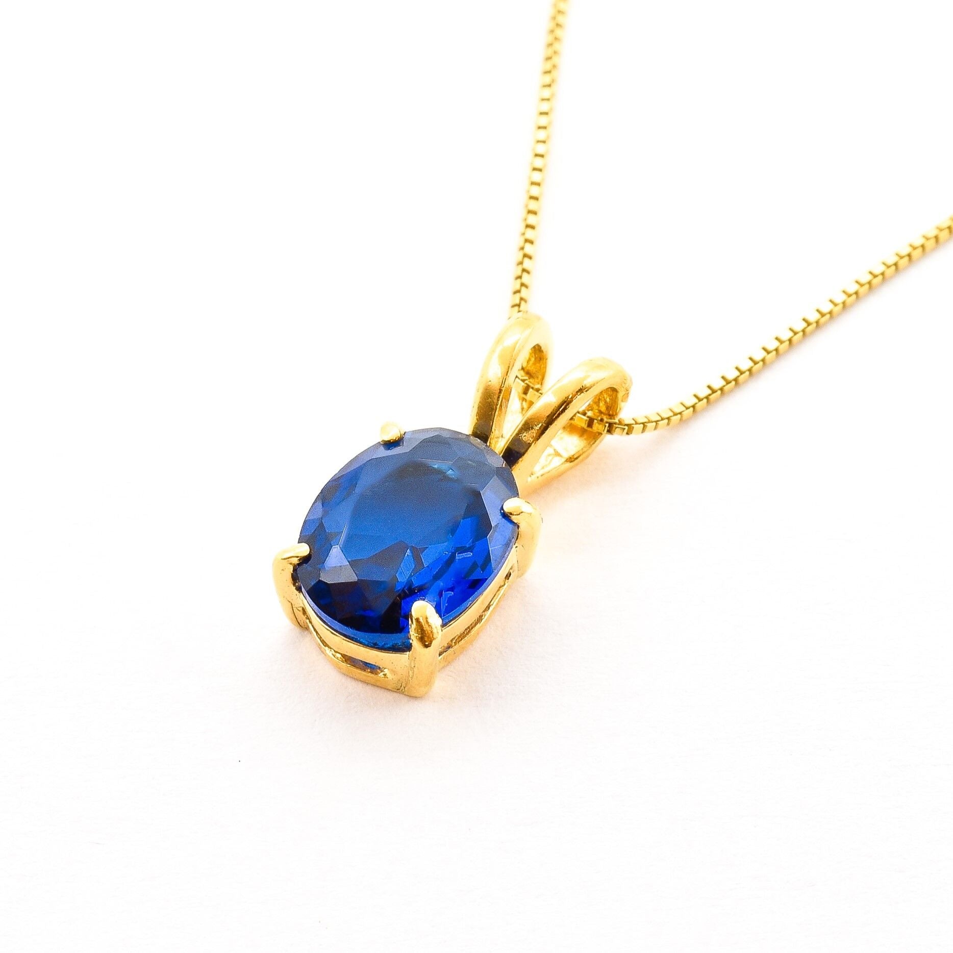Elegant 18k Gold Vermeil pendant with a vibrant oval blue sapphire, symbolizing loyalty and ideal for daily wear.