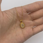 18k yellow gold pendant with natural fire opal October birthstone shown in a hand for scale – handcrafted solitaire necklace