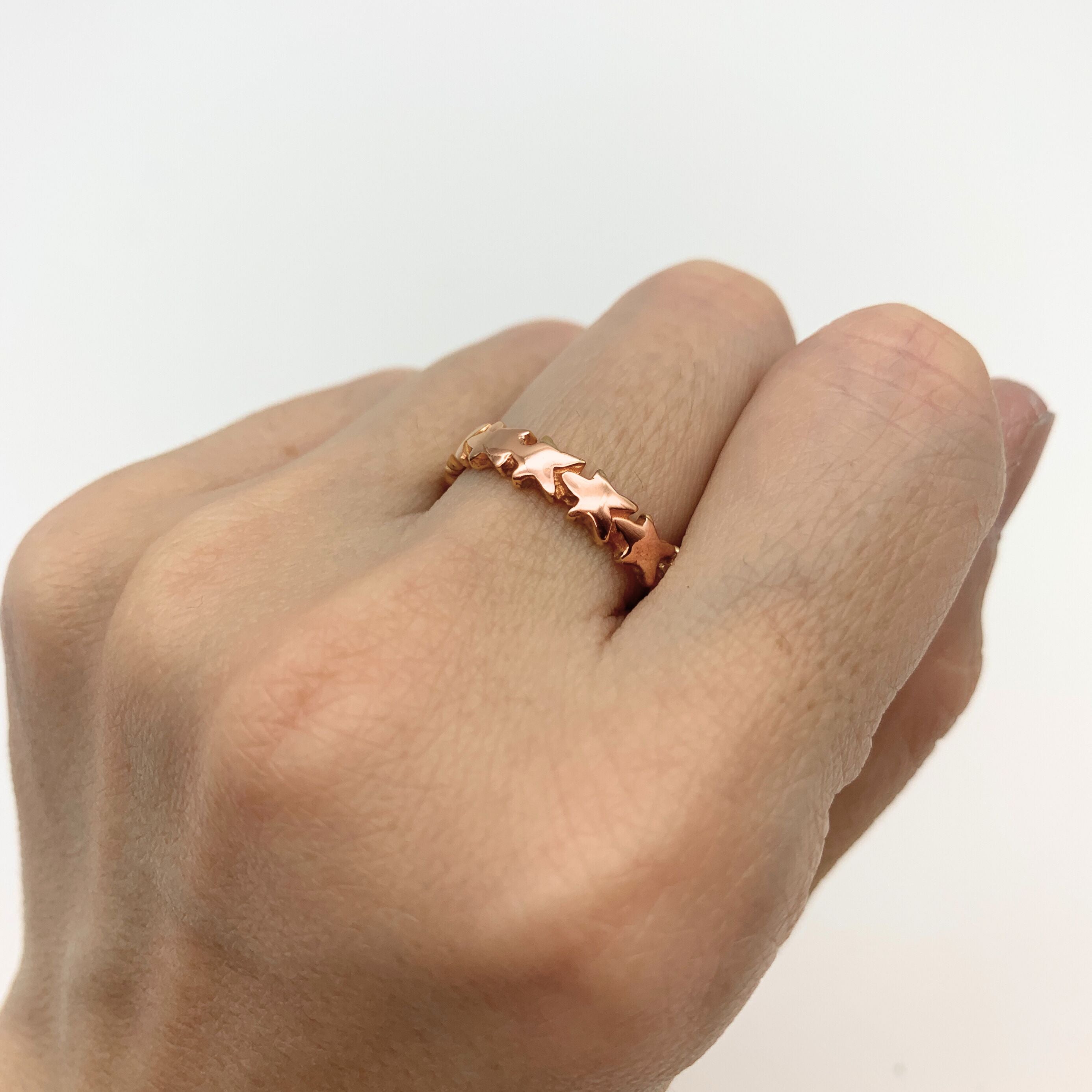 Gold Star Ring, Rose Gold Stacking Ring, Star Eternity Band worn on middle finger