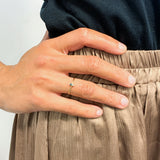 Woman wearing a handcrafted Solid 14k Yellow Gold Ring set with Certified Diamond, and Genuine Blue Diamond gemstones.  Minimalist two -stone ring ideal gift for April birthdays.