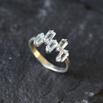 Handcrafted silver band with topaz stones for chic events or gemstone lovers.