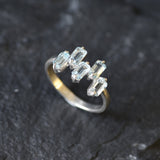 Handcrafted silver band with topaz stones for chic events or gemstone lovers.